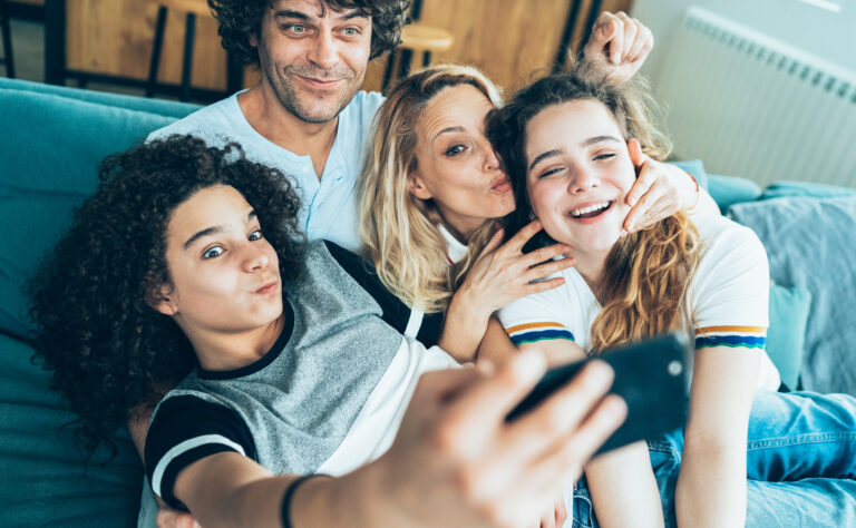 Happy Family with teenage children taking selfie