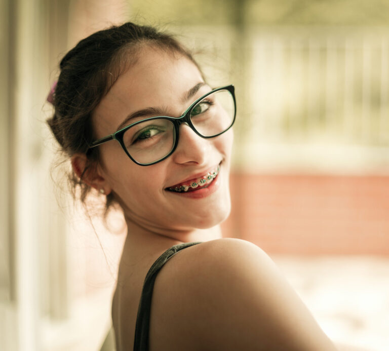 Teenager girl with eyeglasses and braces doing homework