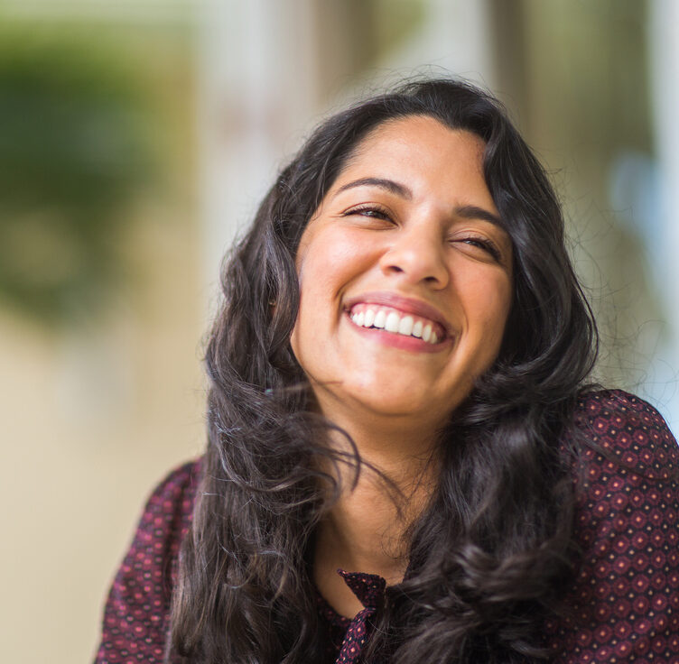 Portrait of a Hispanic woman smiling.